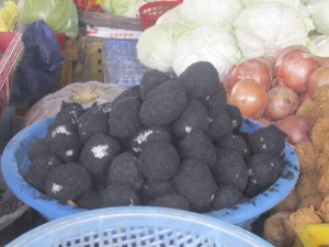 Salted duck eggs (black) are rolled in ashes and left for a month...then boiled.